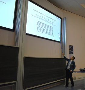 Professor Wilson Poon is in front of a whiteboard presenting some of his science.