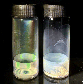 Two test tubes coated with thin film dispersions are shown. One is displaying a variety of colours, the other is opaque and matte in appearance.